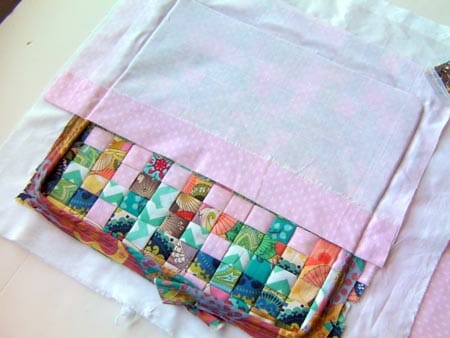 Woven fabric pillow made from weaving strips of folded fabric. Great scrap buster and so pretty too!