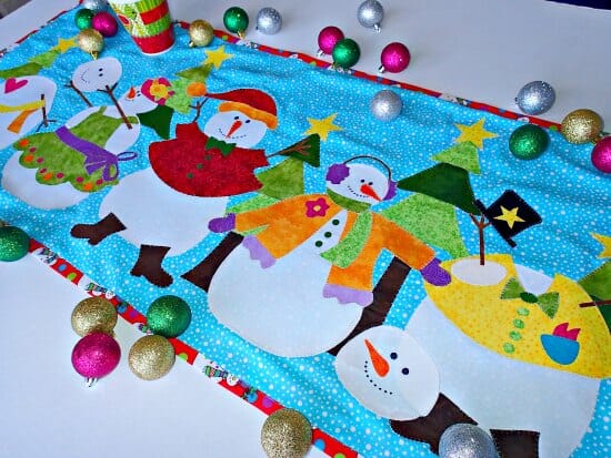 Love the bright colors in this snowman table runner. Would also make a great mini quilt or wall hanging.