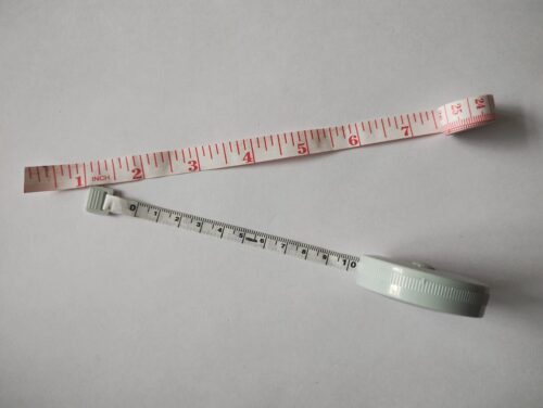 Several tailor tape measures coiled together