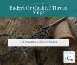 Thread snips and small sewing scissors beside a spool of thread